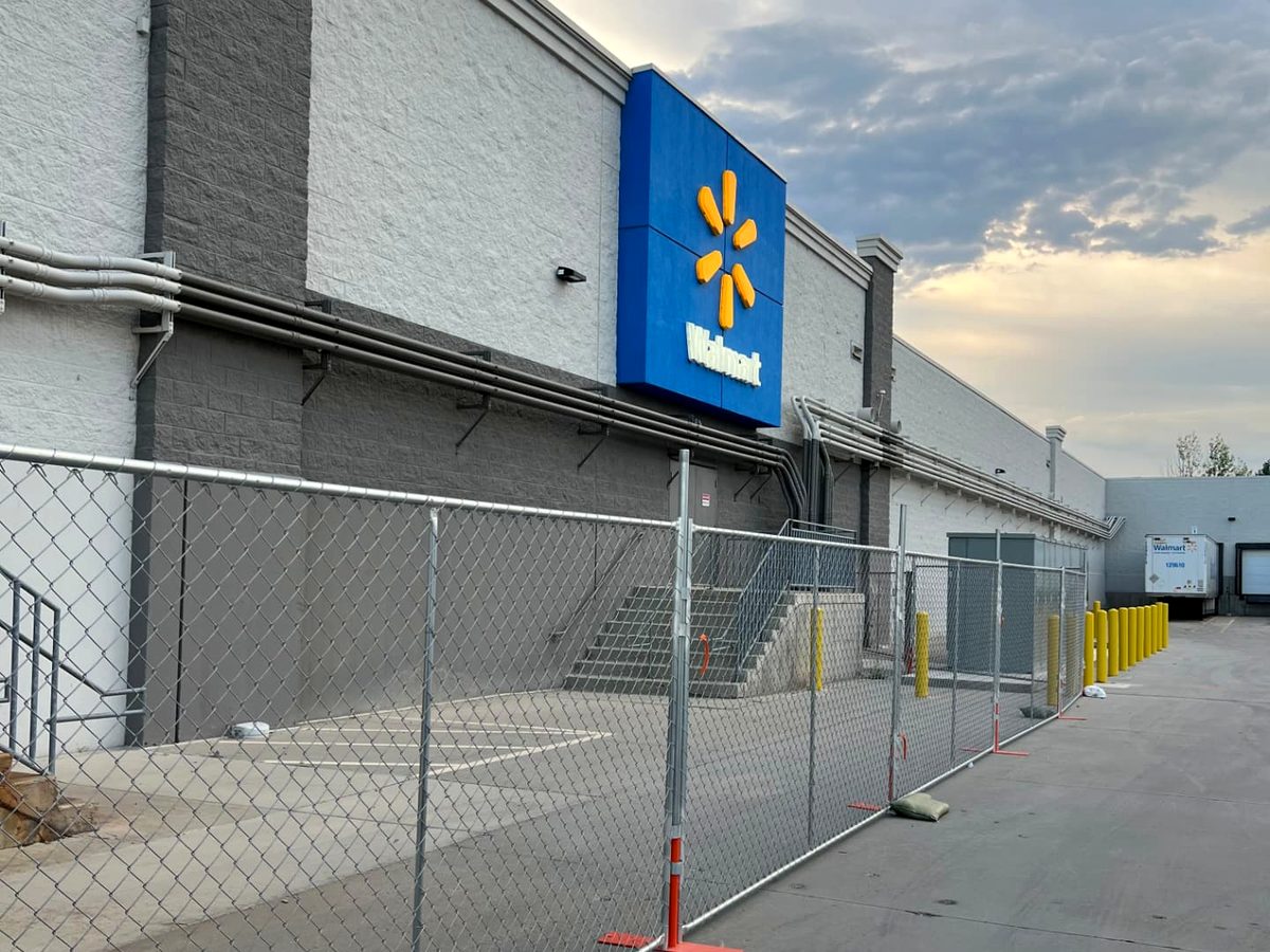 Chain link temporary fence securing a Walmart storefront renovation